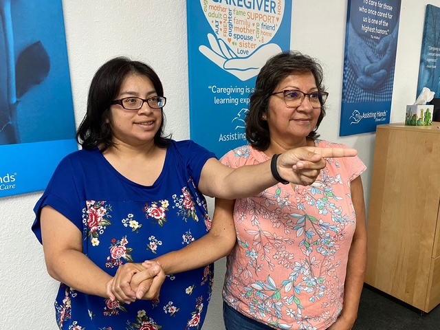 Two caregivers sharing a light moment during training